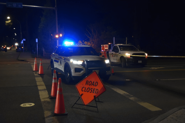 RCMP vehicle blocks a road at a nighttime Surrey crime scene after a targeted shooting.