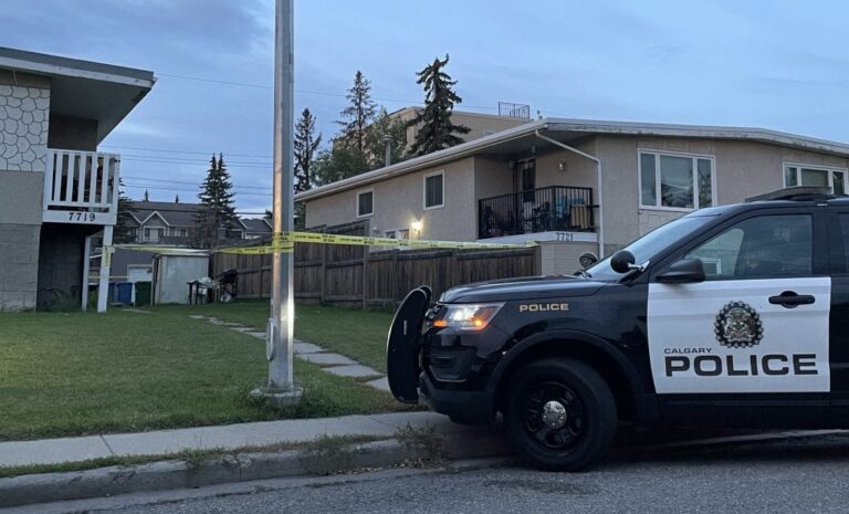 Calgary police investigate a fatal shooting on Bowness Road with crime-scene tape blocking the area.